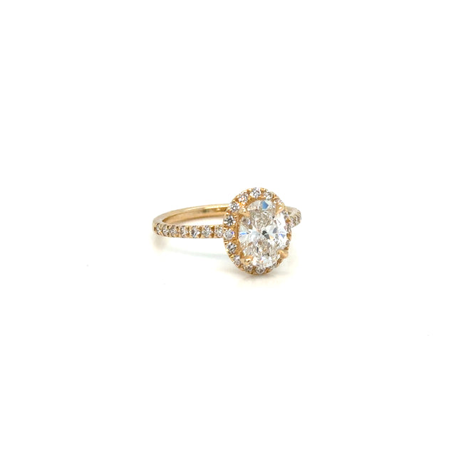1.42 carat oval diamond halo ring on white background – elegant fine jewelry featuring a brilliant oval-cut center diamond surrounded by a halo of smaller diamonds in a timeless setting.