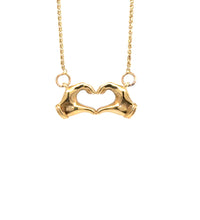 14K gold heart hands necklace on white background – delicate gold chain with hands forming a heart pendant.