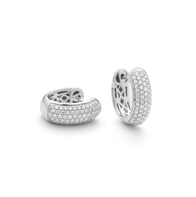 14K white gold diamond huggie earrings on white background – elegant fine jewelry featuring small hoops adorned with sparkling diamonds.