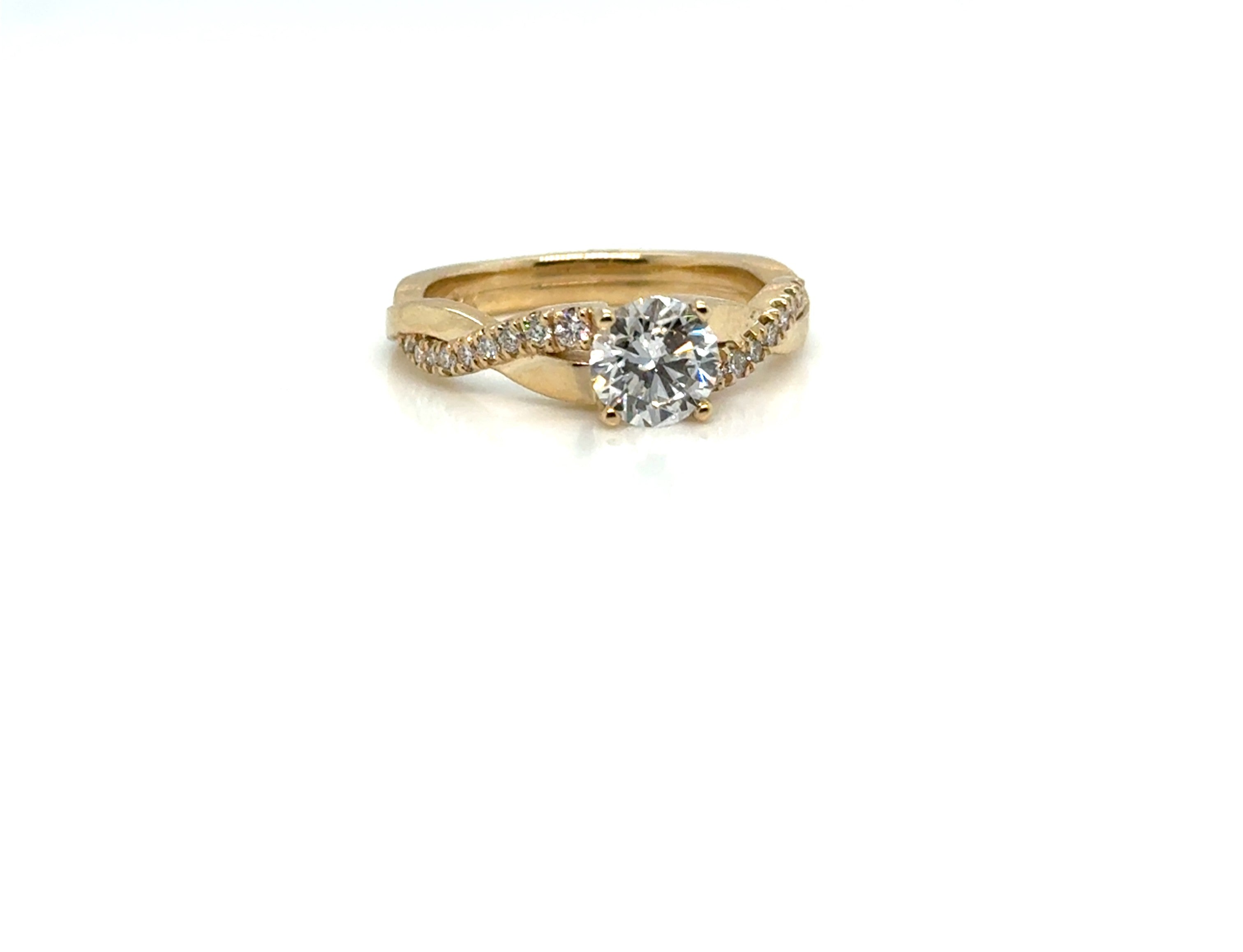 1 carat round diamond twist ring in 14K gold on white background – elegant fine jewelry featuring a brilliant round-cut diamond set in a twisted gold band for a modern, romantic look.