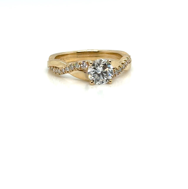1 carat round diamond twist ring in 14K gold on white background – elegant fine jewelry featuring a brilliant round-cut diamond set in a twisted gold band for a modern, romantic look.