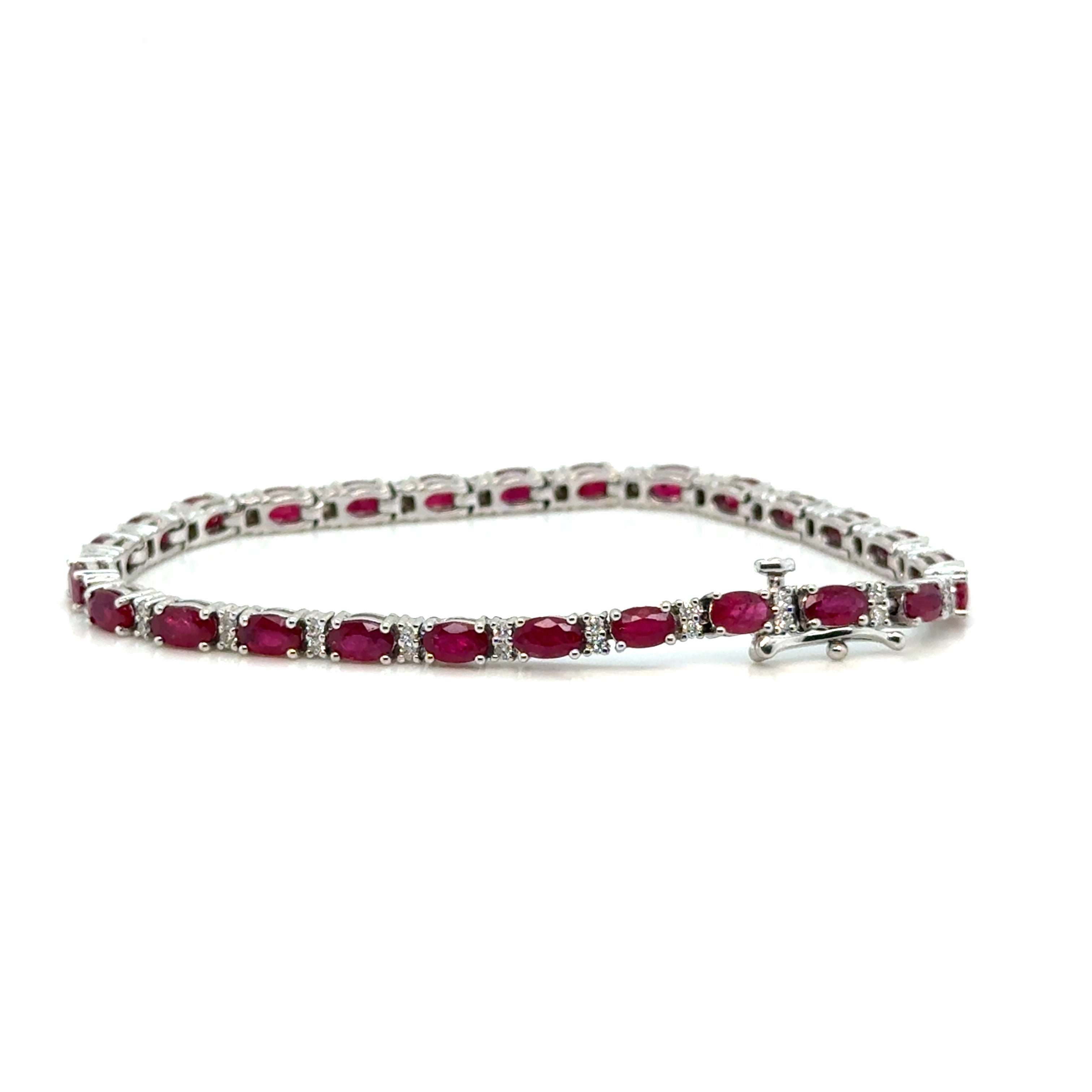 Elegant ruby and diamond bracelet on white background – fine jewelry featuring alternating red rubies and sparkling diamonds in a classic setting.