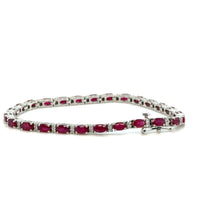Elegant ruby and diamond bracelet on white background – fine jewelry featuring alternating red rubies and sparkling diamonds in a classic setting.