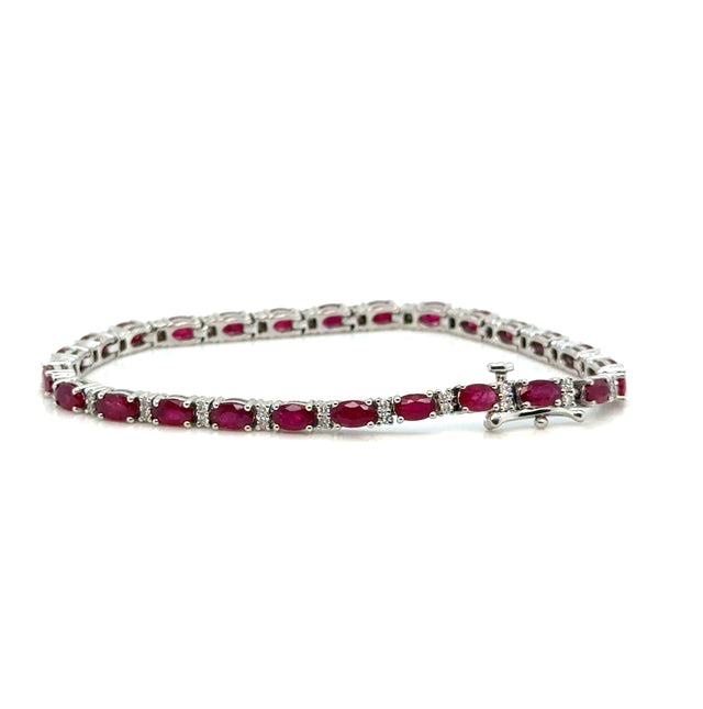 Elegant ruby and diamond bracelet on white background – fine jewelry featuring alternating red rubies and sparkling diamonds in a classic setting.