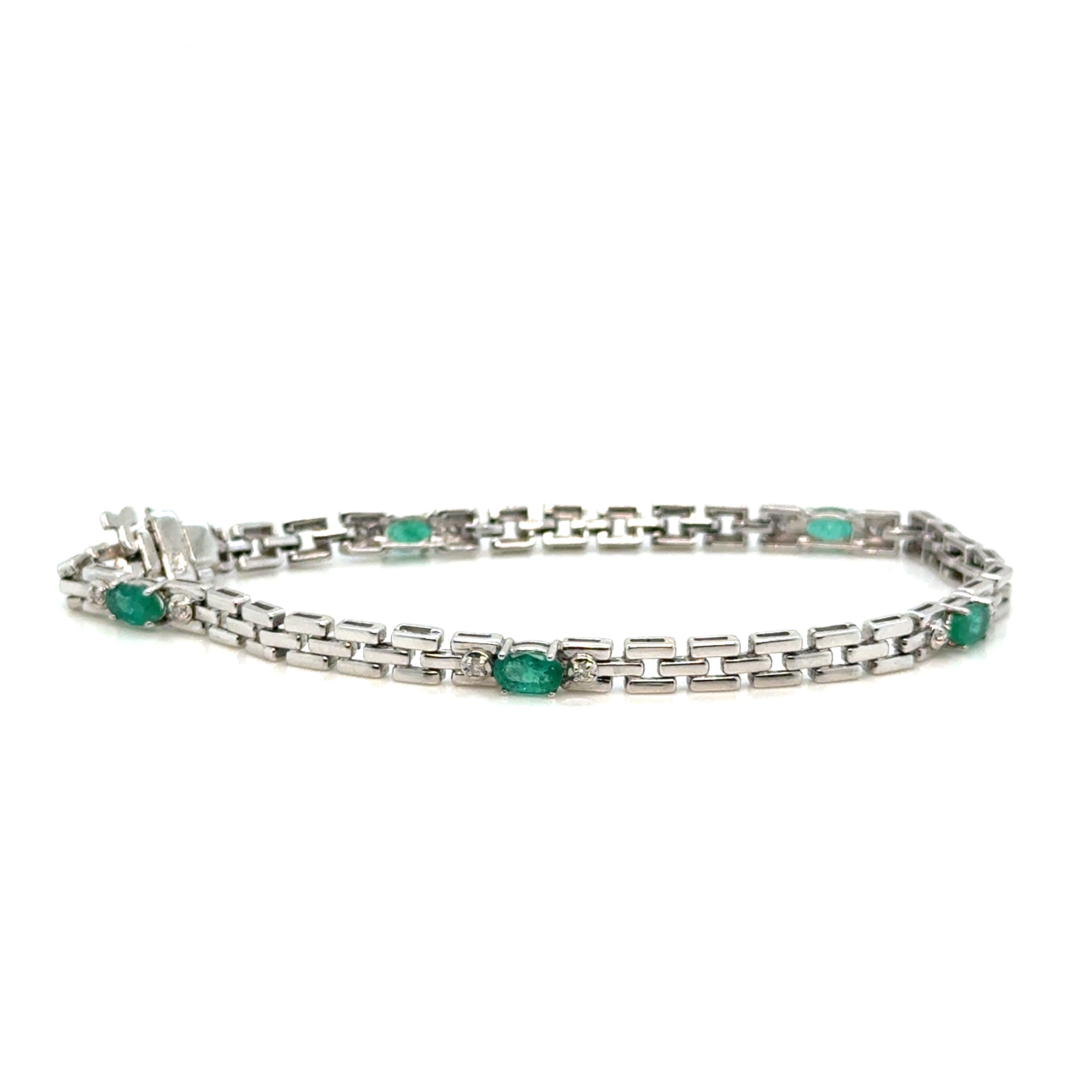 Emerald and diamond 14K white gold bracelet on white background – elegant fine jewelry with vivid green emeralds and sparkling diamonds set in white gold.