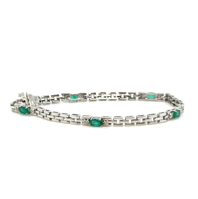 Emerald and diamond 14K white gold bracelet on white background – elegant fine jewelry with vivid green emeralds and sparkling diamonds set in white gold.