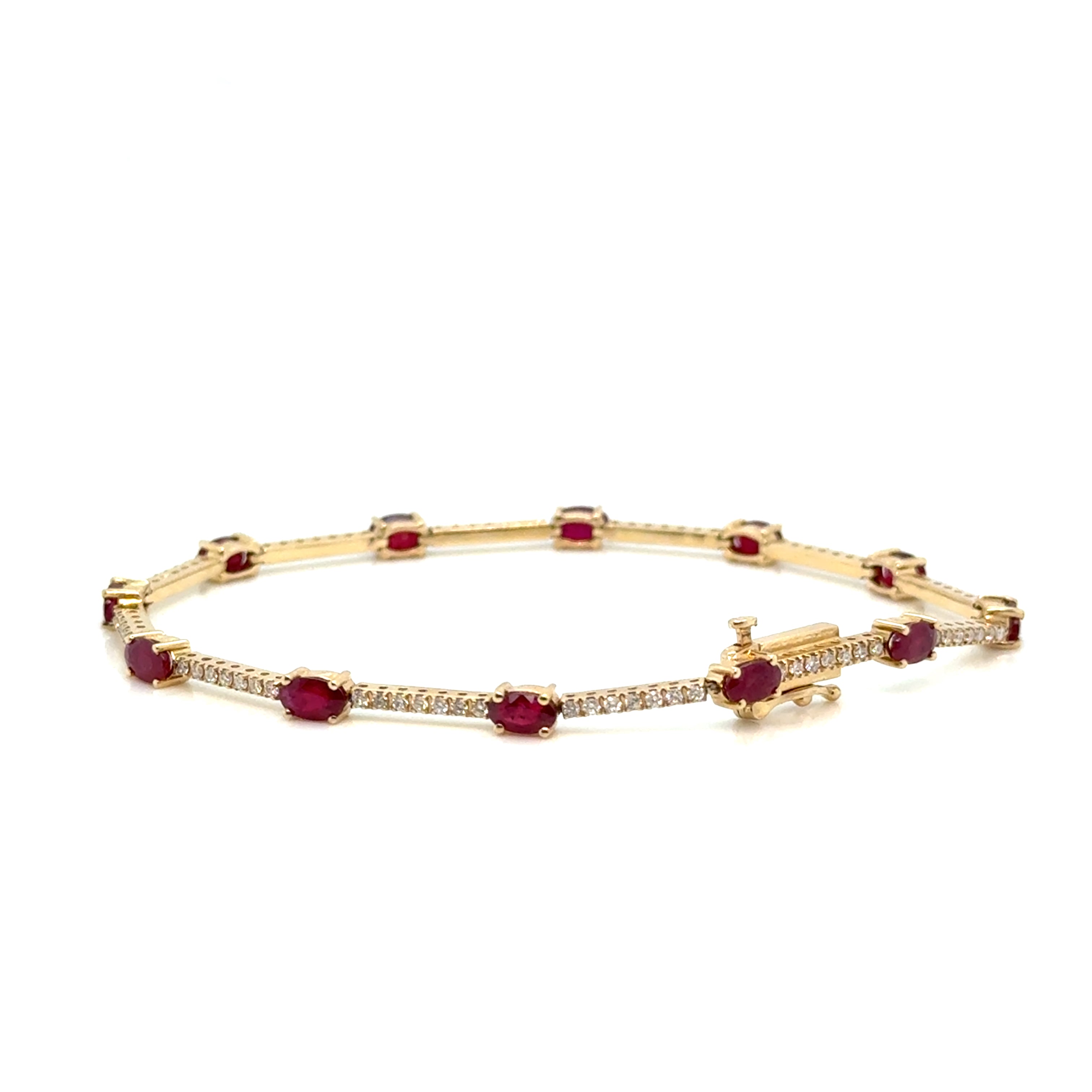 Ruby and diamond 14K gold bracelet on white background – elegant fine jewelry with alternating red rubies and sparkling diamonds set in yellow gold.