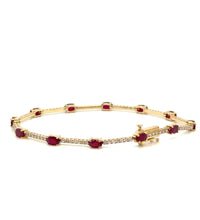 Ruby and diamond 14K gold bracelet on white background – elegant fine jewelry with alternating red rubies and sparkling diamonds set in yellow gold.