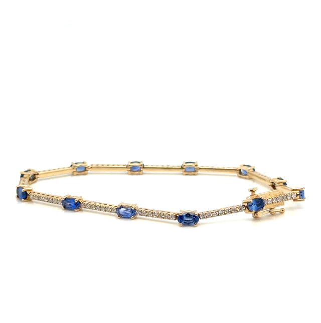 Sapphire and diamond 14K gold bracelet on white background – fine jewelry featuring deep blue sapphires and brilliant diamonds set in yellow gold.