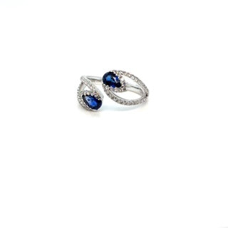 Sapphire and diamond open ring on white background – modern 14K gold ring featuring blue sapphire and brilliant diamond accents in an open band design.